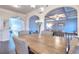 Open dining room showcasing view to blue living room with coffered ceiling and hardwood floors at 910 Shannon Mist Dr, Loganville, GA 30052
