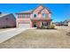 Charming brick home featuring a well-manicured lawn and inviting front entrance at 910 Shannon Mist Dr, Loganville, GA 30052