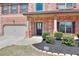 Beautiful brick home featuring an attached garage, manicured bushes, and a welcoming front entrance at 910 Shannon Mist Dr, Loganville, GA 30052