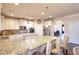 Spacious kitchen featuring granite countertops, island seating, and stainless steel appliances at 910 Shannon Mist Dr, Loganville, GA 30052