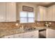 Kitchen featuring white cabinets, granite countertops, and stainless steel appliances at 910 Shannon Mist Dr, Loganville, GA 30052