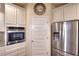 Kitchen featuring stainless steel fridge and appliances, white cabinets, and granite countertops at 910 Shannon Mist Dr, Loganville, GA 30052