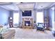 Cozy living room features fireplace, TV, coffered ceiling, and comfortable seating at 910 Shannon Mist Dr, Loganville, GA 30052
