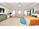 Large main bedroom offering a sitting area, workstation, and plenty of natural light from multiple windows at 910 Shannon Mist Dr, Loganville, GA 30052