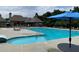 Community pool with multiple lounge chairs and tables with umbrellas at 910 Shannon Mist Dr, Loganville, GA 30052