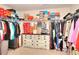 Walk-in closet with clothes, shelves, and shoe boxes at 910 Shannon Mist Dr, Loganville, GA 30052