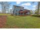 View of the backyard with a two-story deck on a blue home with a spacious lawn at 2735 Peachtree Walk, Duluth, GA 30096