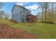 View of the backyard featuring a spacious lawn and a two-story deck on a blue home at 2735 Peachtree Walk, Duluth, GA 30096