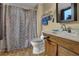 A bathroom features a sink, toilet, and decorative shower curtain at 2735 Peachtree Walk, Duluth, GA 30096