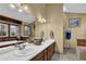 Dual sink bathroom features a long vanity, wall-to-wall mirror and a jetted tub with views at 2735 Peachtree Walk, Duluth, GA 30096