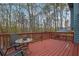 Outdoor deck with seating offers a serene wooded view at 2735 Peachtree Walk, Duluth, GA 30096