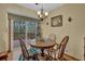 A dining area features wooden chairs, wood floors, and sliding glass doors to the outside deck at 2735 Peachtree Walk, Duluth, GA 30096