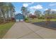 Detached two-car garage with a long driveway leading to a well-maintained front yard at 2735 Peachtree Walk, Duluth, GA 30096