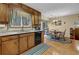 A kitchen features granite countertops, wooden cabinets, and a dining area at 2735 Peachtree Walk, Duluth, GA 30096