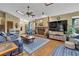 Living room with fireplace, ceiling fan, hardwood floors, and blue furniture sets at 2735 Peachtree Walk, Duluth, GA 30096