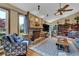 Living room with hardwood floors, stone fireplace, ceiling fan, and book shelves at 2735 Peachtree Walk, Duluth, GA 30096