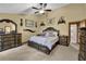Spacious main bedroom with large bed, ceiling fan, and ensuite bathroom access at 2735 Peachtree Walk, Duluth, GA 30096