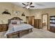 Bright main bedroom features a plush bed, ceiling fan, and ensuite bathroom at 2735 Peachtree Walk, Duluth, GA 30096
