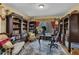Office featuring dark wood built-in book shelves, a desk, and a carpeted floor at 2735 Peachtree Walk, Duluth, GA 30096