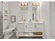 Well-lit bathroom featuring a double vanity with marble counters and modern fixtures and a toilet at 923 Peachtree Ne St # 939, Atlanta, GA 30309