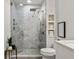 Modern bathroom with glass enclosed shower, decorative tile, and floating shelves at 923 Peachtree Ne St # 939, Atlanta, GA 30309