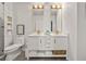 Well-lit bathroom featuring a double vanity, modern fixtures, and a stylish toilet at 923 Peachtree Ne St # 939, Atlanta, GA 30309