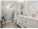 Elegant bathroom featuring double vanity sinks, brass hardware, a modern walk-in shower and marble accents at 923 Peachtree Ne St # 939, Atlanta, GA 30309