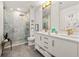 Bright bathroom with double vanity, marble shower, and gold fixtures at 923 Peachtree Ne St # 939, Atlanta, GA 30309