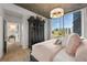 Bright bedroom with large windows and a view, featuring an armoire and hardwood floors at 923 Peachtree Ne St # 939, Atlanta, GA 30309