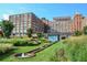 Beautiful exterior view of Ponce City Market with lush green landscaping and water feature at 923 Peachtree Ne St # 939, Atlanta, GA 30309