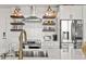 Modern kitchen with stainless steel appliances, white cabinets, and open shelving at 923 Peachtree Ne St # 939, Atlanta, GA 30309