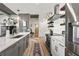 Open-concept kitchen with stainless steel appliances and island, seamlessly flowing into the living area at 923 Peachtree Ne St # 939, Atlanta, GA 30309