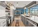 Modern kitchen with stainless steel appliances, white herringbone backsplash and expansive windows with city views at 923 Peachtree Ne St # 939, Atlanta, GA 30309