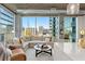 Cozy living room with floor-to-ceiling windows providing plenty of natural light and views of the city skyline at 923 Peachtree Ne St # 939, Atlanta, GA 30309