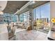 Bright open concept living room with floor to ceiling windows and concrete ceilings at 923 Peachtree Ne St # 939, Atlanta, GA 30309