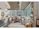 Bright open concept living room with floor to ceiling windows and concrete ceilings at 923 Peachtree Ne St # 939, Atlanta, GA 30309