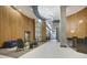 Modern condo lobby featuring contemporary furniture, wood wall paneling, and a decorative light fixture at 923 Peachtree Ne St # 939, Atlanta, GA 30309