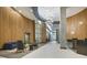 A modern lobby featuring wood paneling, a unique light fixture, and seating areas at 923 Peachtree Ne St # 939, Atlanta, GA 30309