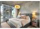 Cozy main bedroom with city views, chandelier, and a neutral color palette at 923 Peachtree Ne St # 939, Atlanta, GA 30309