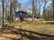 A backyard featuring mature trees and grass, with a partial view of the house at 2943 E Howell Dr, Lawrenceville, GA 30044