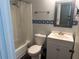 Bathroom featuring a white vanity, toilet, shower, and blue decorative accents against gray walls at 2943 E Howell Dr, Lawrenceville, GA 30044