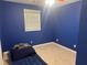 A blue-walled bedroom with carpeted floors and a cozy ambiance at 2943 E Howell Dr, Lawrenceville, GA 30044