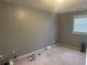 Neutral bedroom with light gray walls, carpet, one window, and electrical cords on the floor at 2943 E Howell Dr, Lawrenceville, GA 30044