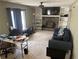 Cozy living room with a stone fireplace, built-in shelves, and plush seating at 2943 E Howell Dr, Lawrenceville, GA 30044