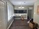 An open-plan living area with hardwood floors and neutral-colored walls and a decorative chandelier at 2943 E Howell Dr, Lawrenceville, GA 30044