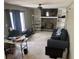 Cozy living room with a stone fireplace, built-in shelves, and plush seating at 2943 E Howell Dr, Lawrenceville, GA 30044