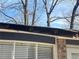 Image shows close-up view of damage to the roofline over the windows on the back of the home at 2943 E Howell Dr, Lawrenceville, GA 30044