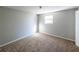 Bedroom featuring neutral walls, carpeted floors and window bringing in natural light at 6225 Pebble Dr, Douglasville, GA 30135