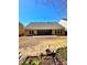New home backyard with concrete patio and a seeded lawn with some foliage at 779 Harvest Brook Dr, Lawrenceville, GA 30043