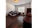 Cozy bedroom featuring hard wood floors, natural light from window, and dark furniture at 779 Harvest Brook Dr, Lawrenceville, GA 30043